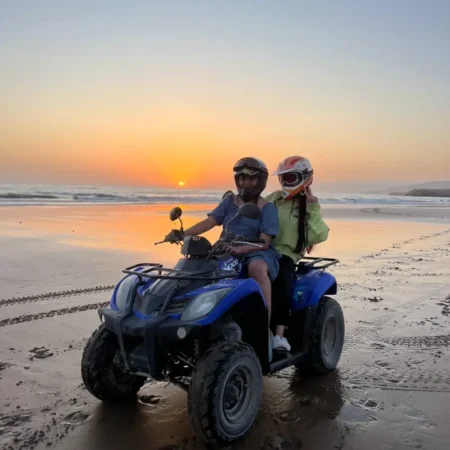 Couple enjoying quad biking on Agadir beach Morocco
