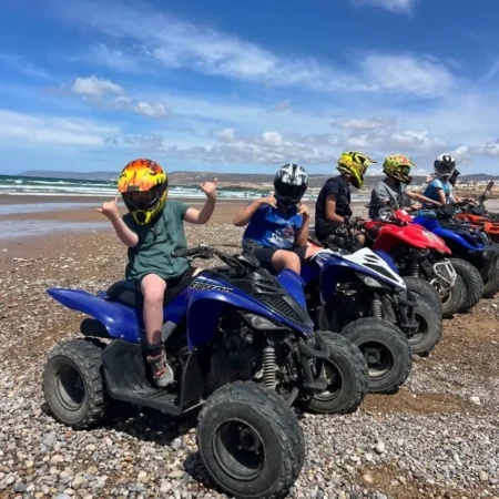 Tourists riding quad bikes along Agadir beach Morocco